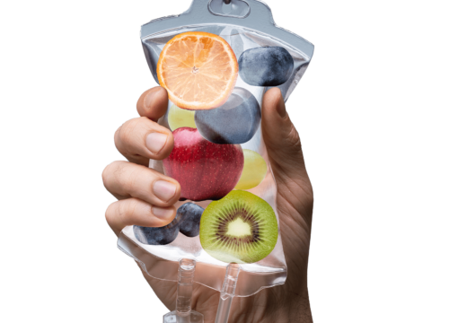 Photo of a hand holding an IV bag full of fruit