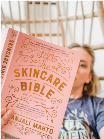 Woman reading a Skincare Bible