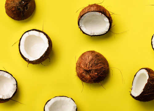 Coconuts used for coconut water on a yellow background
