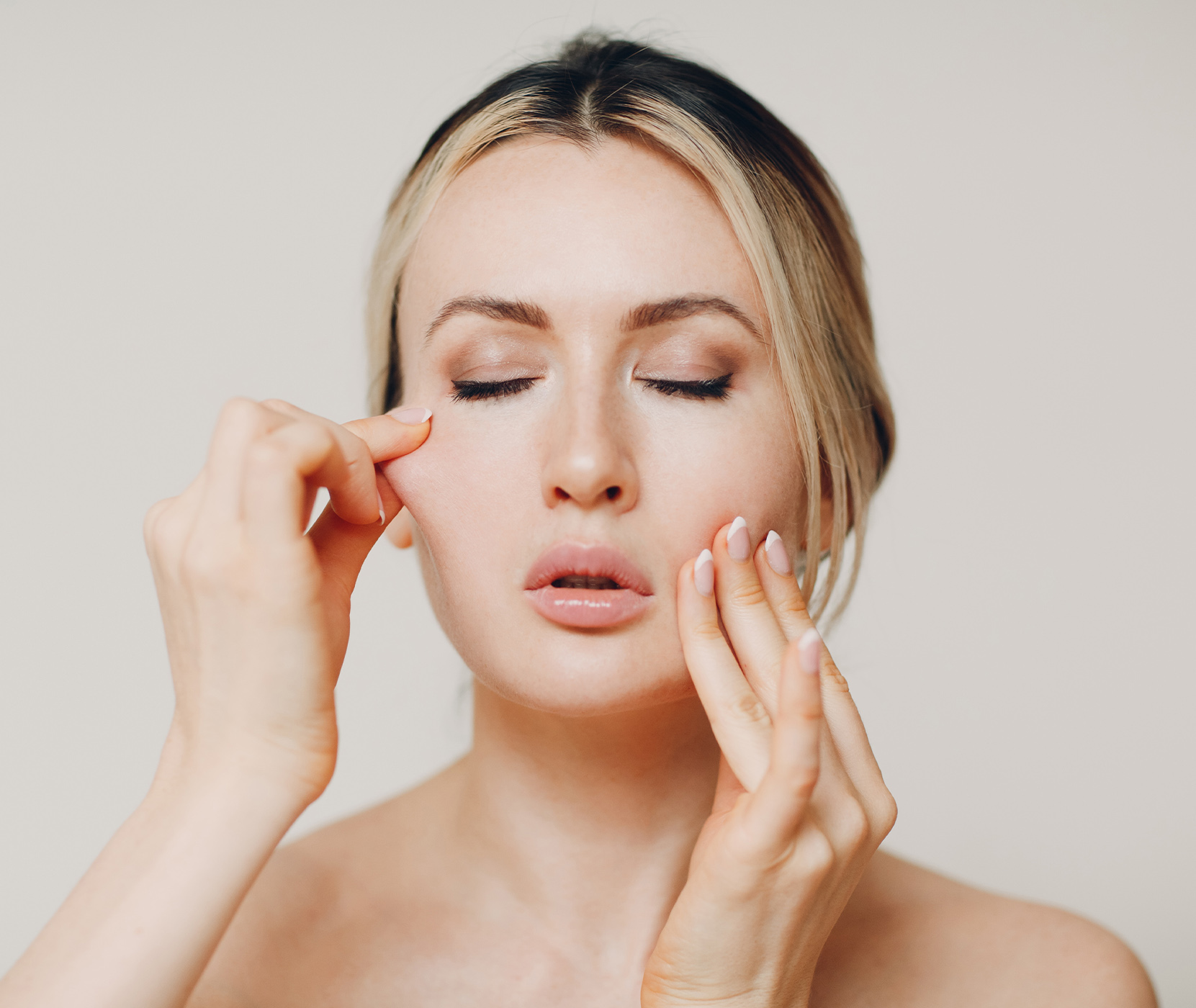 Woman pinching the skin on her face