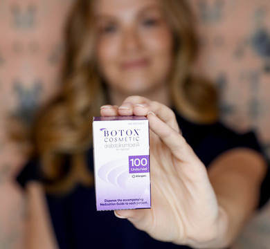 Photo of Melissa holding up a box of BOTOX<sup>®</sup> Cosmetic
