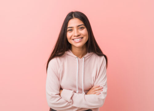 Photo of a happy teenage girl in a pink hoodie